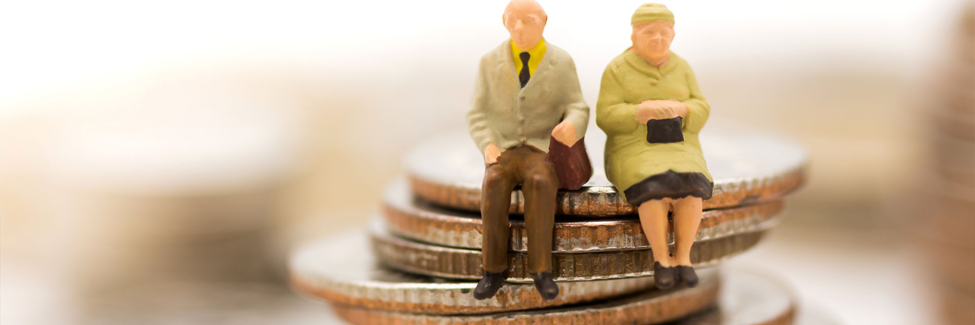 Image showing a model of an older couple sitting on a large piles of coins