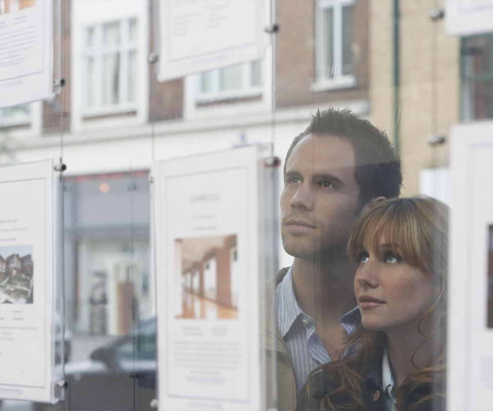 Image showing a couple looking in an estate agent's window