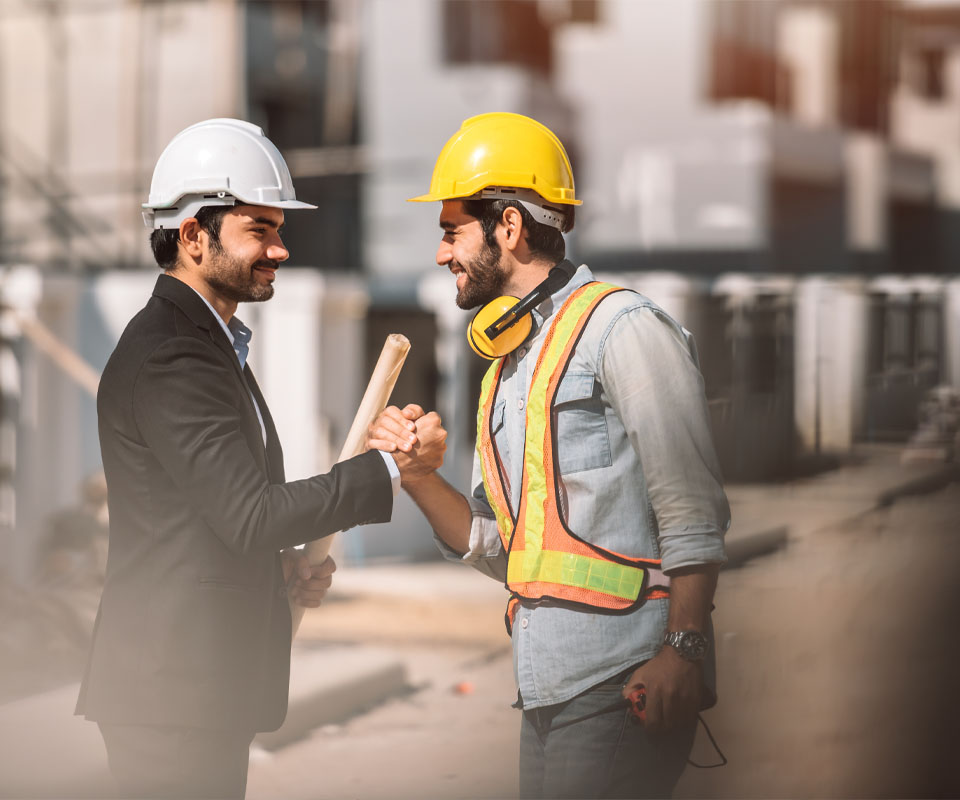 Image showing a business man and a contractor shaking hands on a building site