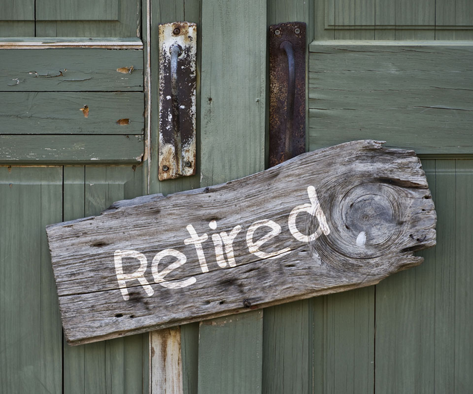 Image showing a wooden door with a sign saying "Retired" on it