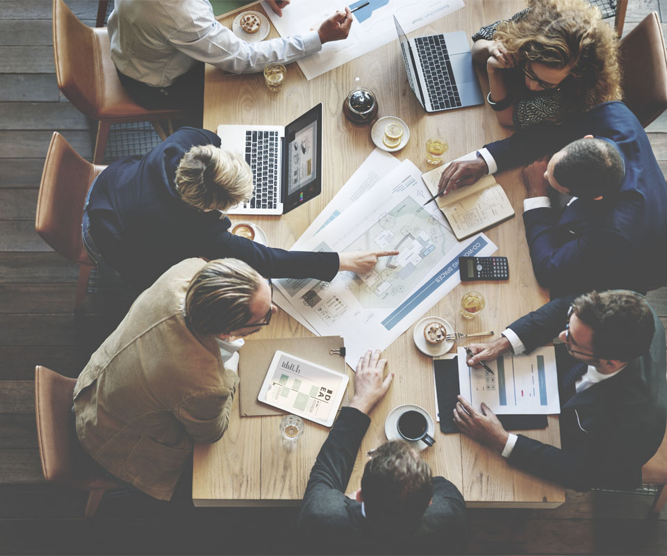 Image showing an overhead view of a group of business people working round a desk