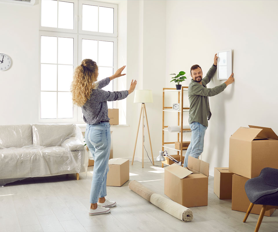 Image showing a young couple unpacking boxes and decorating their new home