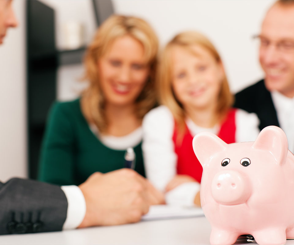 Image showing a family in a meeting with an adviser with a piggy bank on the table