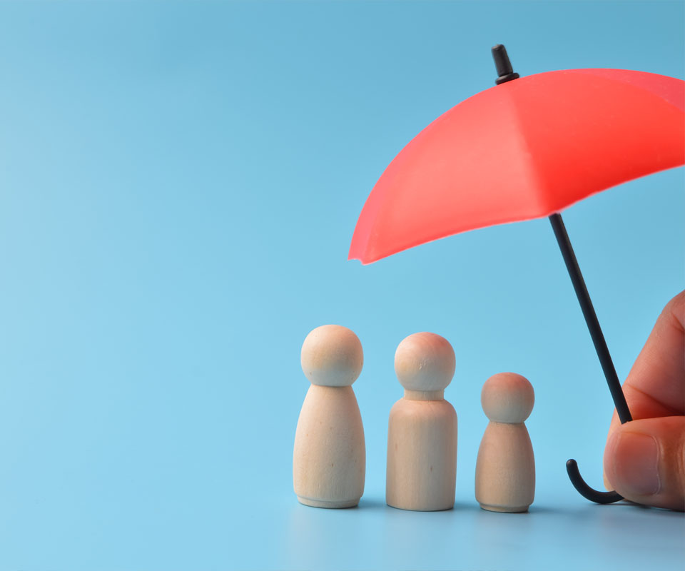 Image showing a model family being protected by a mini umbrella being held by a hand out of shot