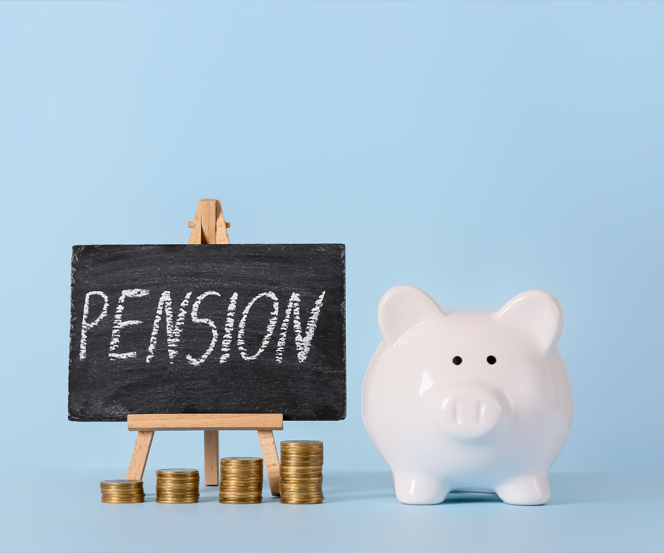 Image showing a piggy bank next to some piles of coins and a small chalkboard with the word "Pension" on it