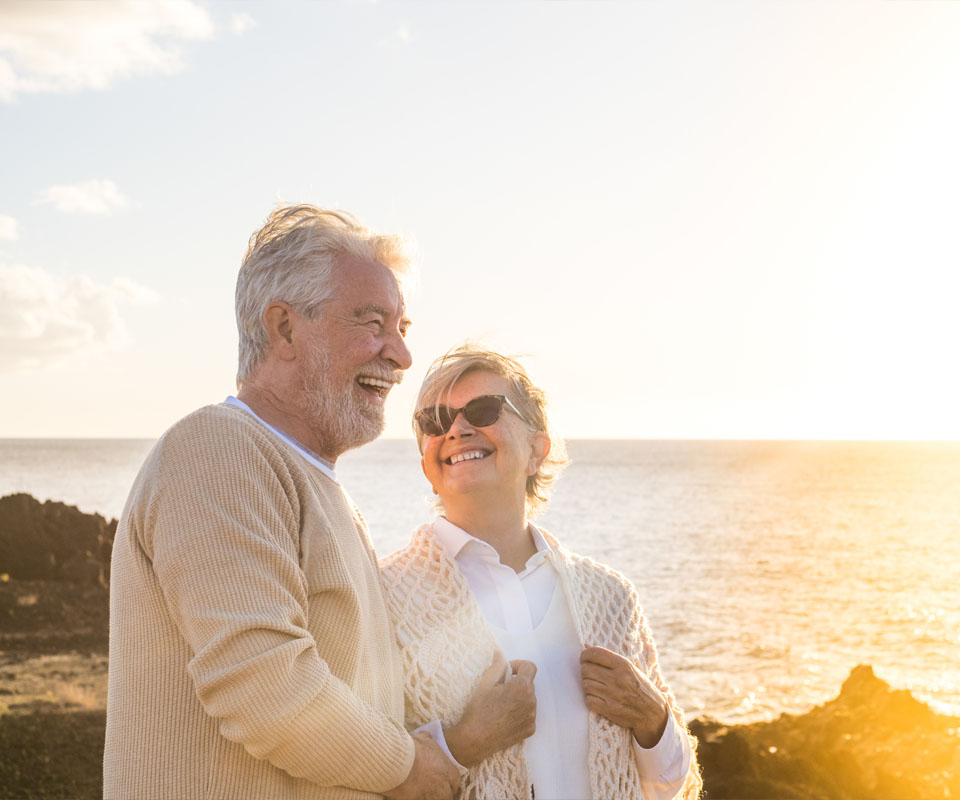Image showing a smiling older couple walking by the sea