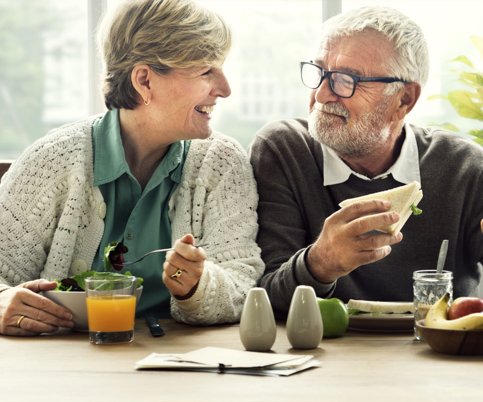 Image showing a smiling older couple eating breakfast together