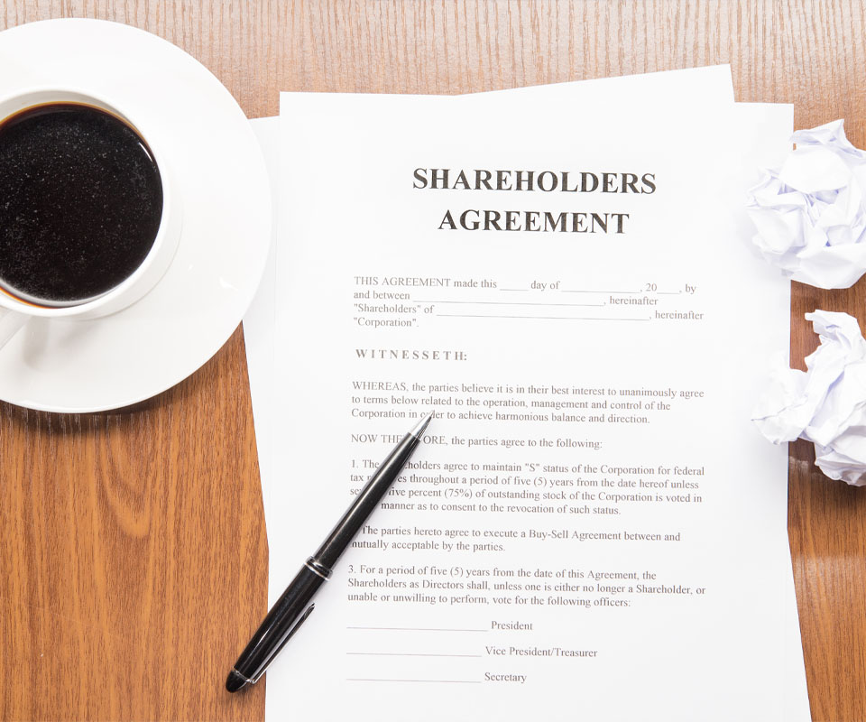 Image showing a cup of coffee and some documents labelled "Shareholders agreement"