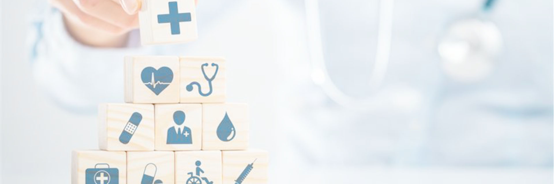 Image of a doctor building blocks with medical icons printed on them