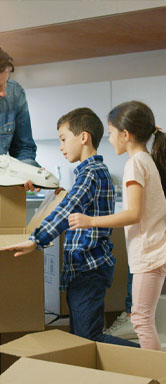 Image showing a family unpacking boxes together