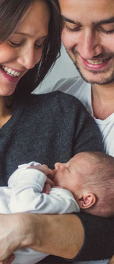 Image showing a happy couple holding a newborn