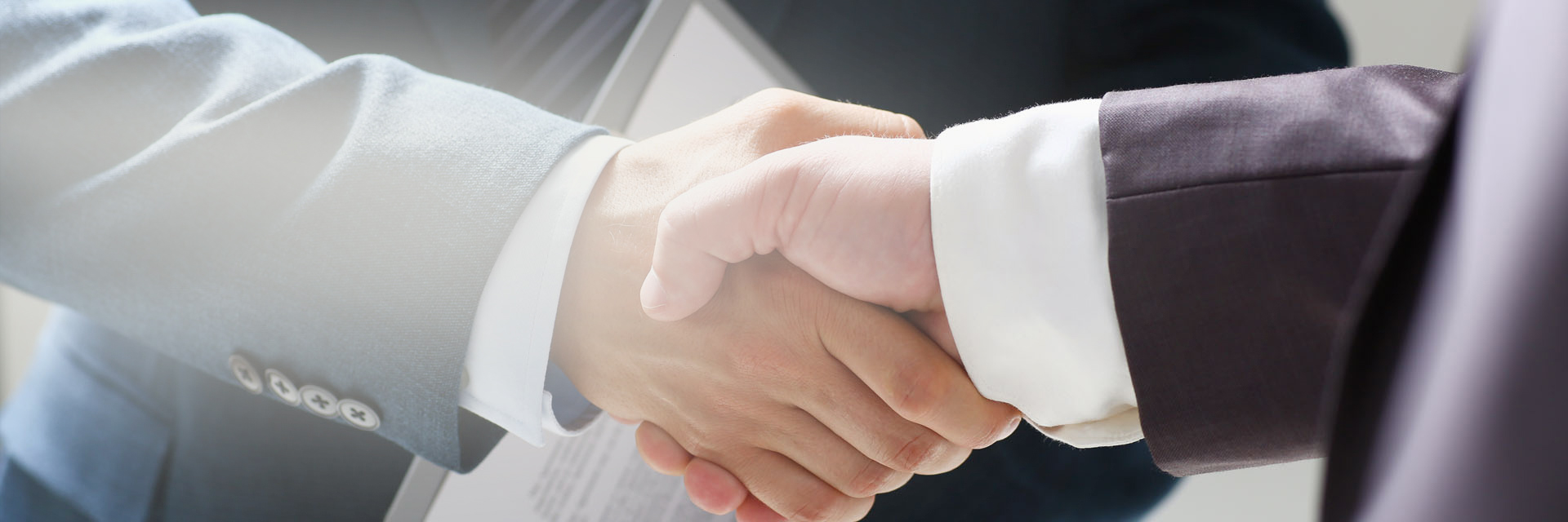 Image showing two men in suits shaking hands