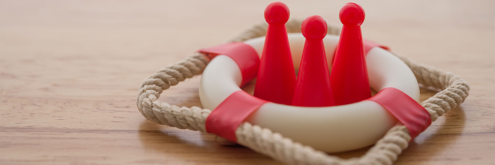Image showing three red pawns inside of a model of a lifebuoy 
