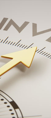 Image showing a close up of a compass pointing to the word "invest"