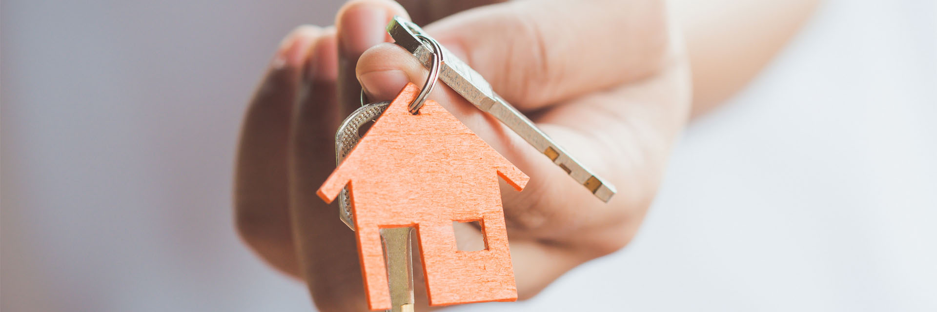 Image showing a close up of a hand holding a set of keys with a house keyring