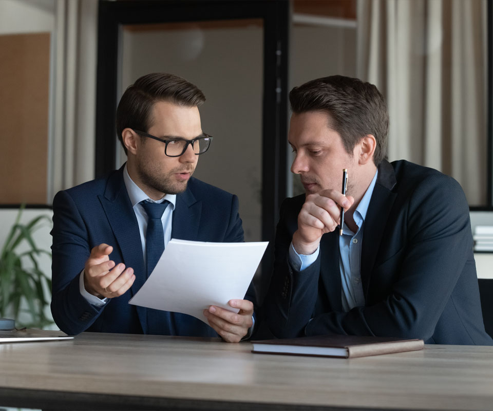 Image showing two men in a meeting going through some paperwork together