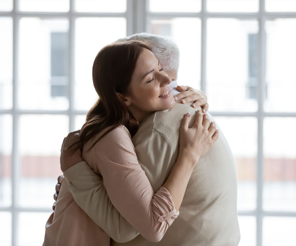 Image showing a young woman hugging an elderly man